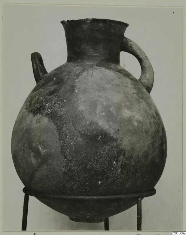 Black Slip Ware hydria: a globular vessel with a flaring neck and two handles, on a metal stand