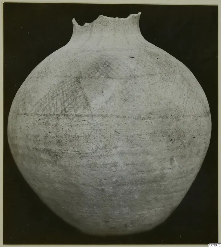 White Painted Wheel-made jar with a broken rim and faint crosshatched painted pattern on the shoulder