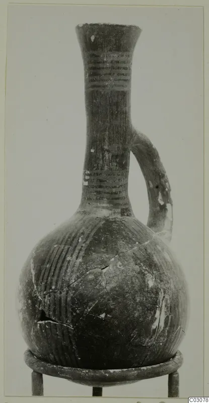 Single-handled jug with a flaring rim, long neck and rounded body, with painted bands on the neck and stripes on the body.