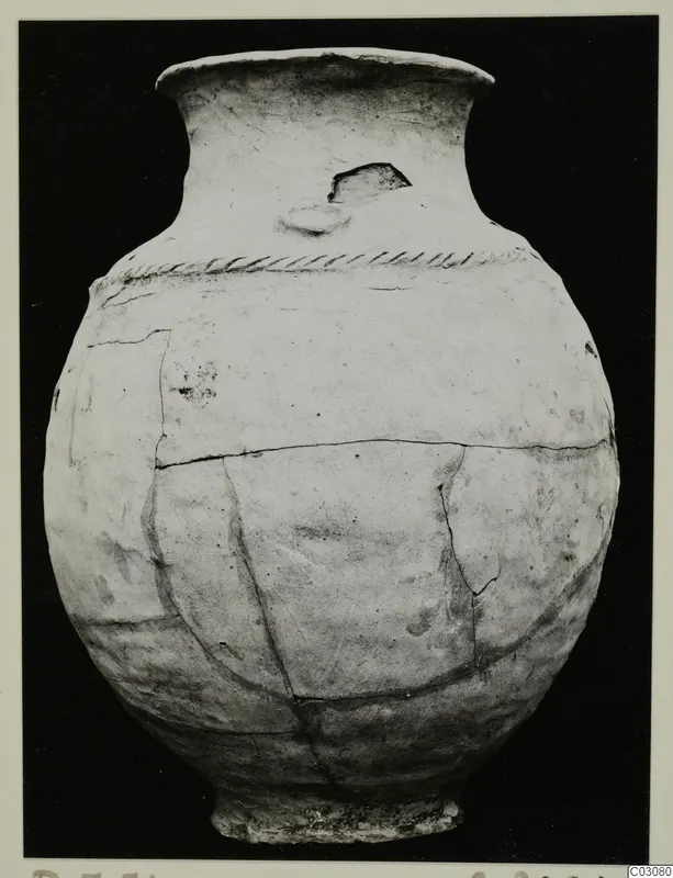 Jar in Plain White Hand-made Ware from the Karpas sites, with a band of impressed decoration below the neck