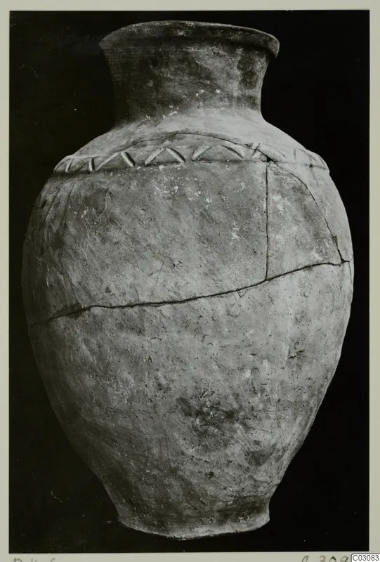 Pottery Plain White Hand-made Ware jar with a narrow neck and a band of slanted marks on the shoulder, against a black background