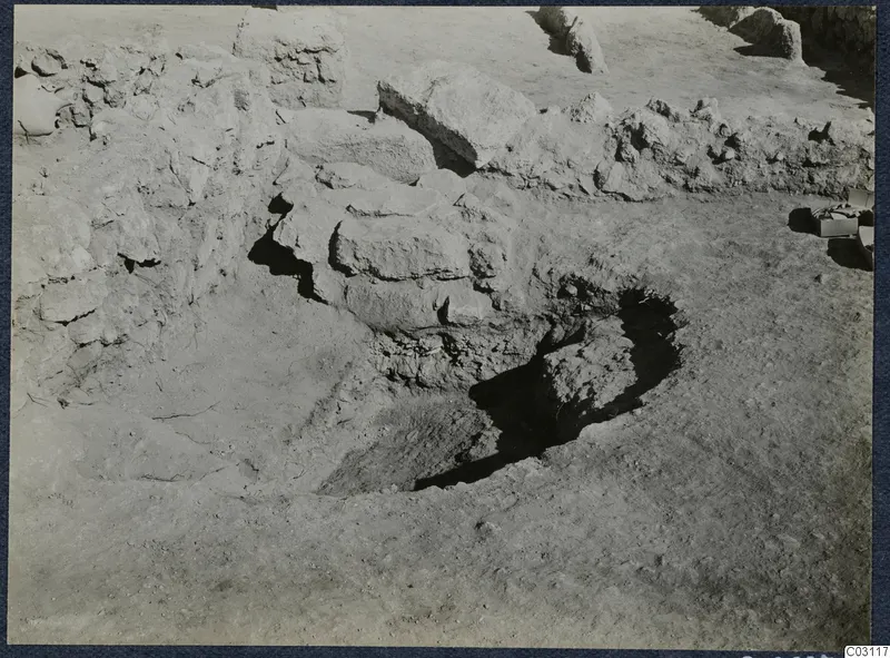 Excavation trench at Vouni Palace with piled stones and low walls