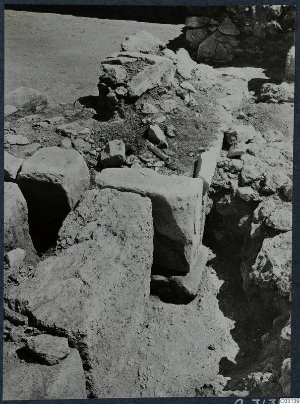 Excavated walls and large squared stone blocks in soil and rubble at the palace at Vouni