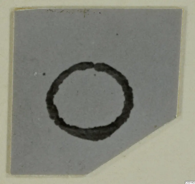 Ring-shaped object with a dark outline on a grey background, shown on a cut-corner card