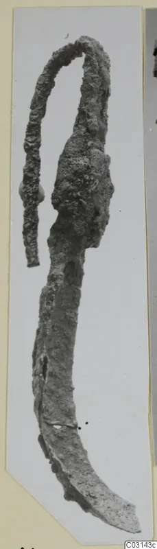 Corroded iron strigil, a long curved implement with a loop at one end, from the Marion tomb finds