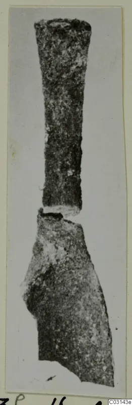 Corroded metal tool from Marion, with a long tapering shank above a broken, broader blade