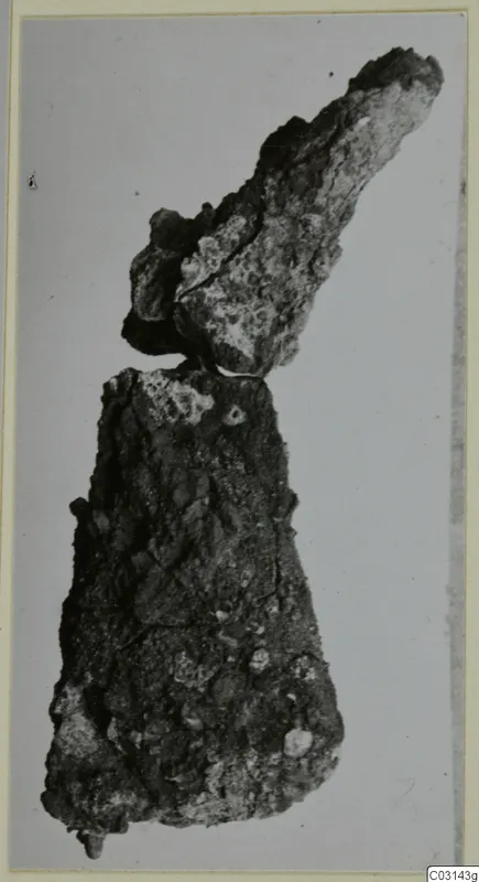 Two corroded iron tool fragments, find from tombs 31–45 at Marion, on a plain pale background
