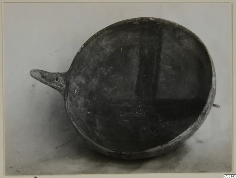 Red-on-Black bowl from Ayios Iakovos with a pointed horizontal handle projecting to the left