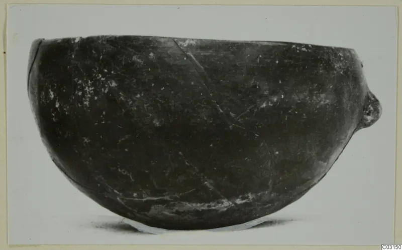 Pottery Red Polished I bowl from Lapithos, photographed in side view against a pale background.