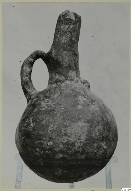 Red Polished III pottery jug from Lapithos, with a single loop handle and a tall neck