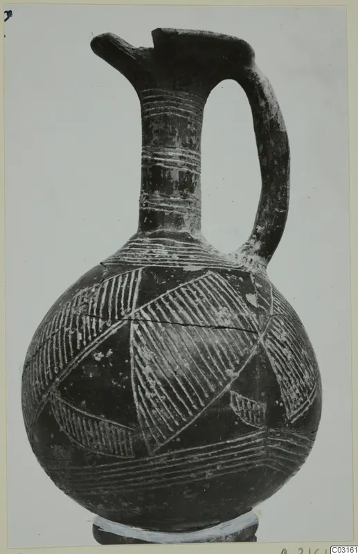 Pottery Red Polished II jug from Lapithos with a pinched spout, strap handle and incised hatched bands