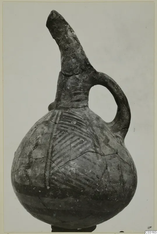 Jug with a tall broken spout and loop handle, painted with hatched bands, from Lapithos