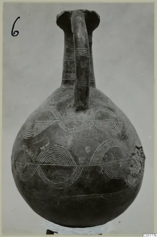 Pottery Red Polished II jug with a single strap handle and pale arc and band decoration