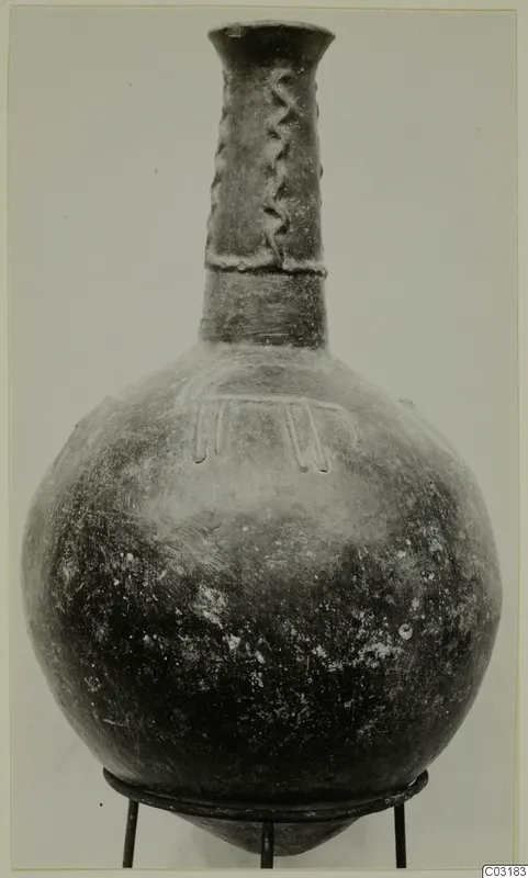Pottery Red Polished II jug with a tall narrow neck and applied decoration, from Lapithos
