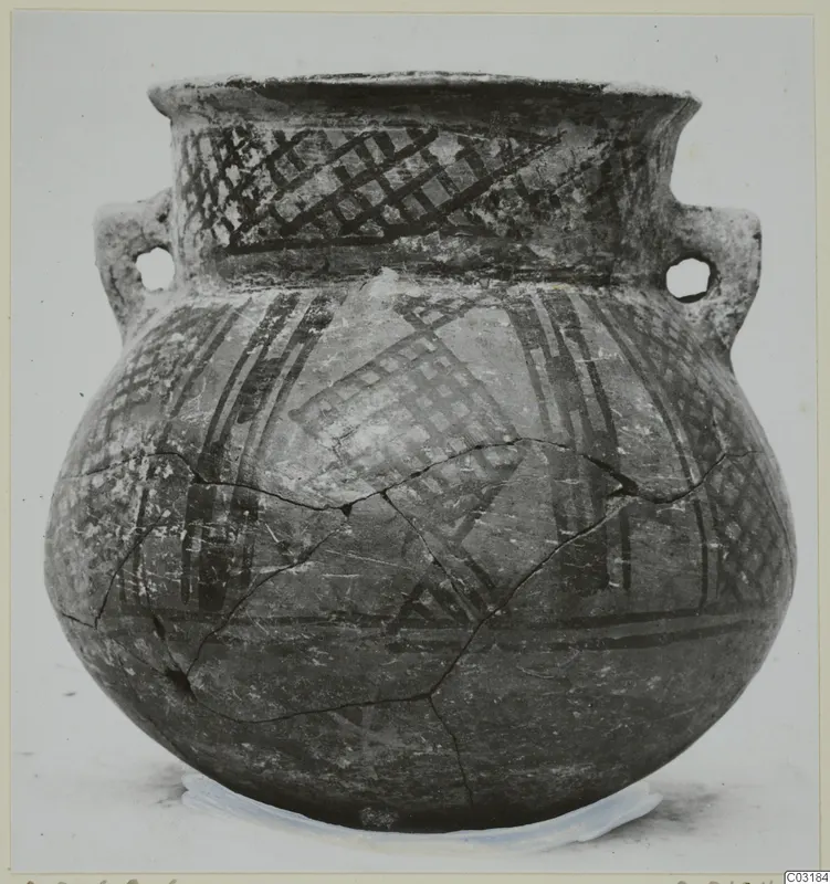 Round-bodied pottery jar with two handles and painted criss-cross and band decoration, shown on a stand against a plain background.