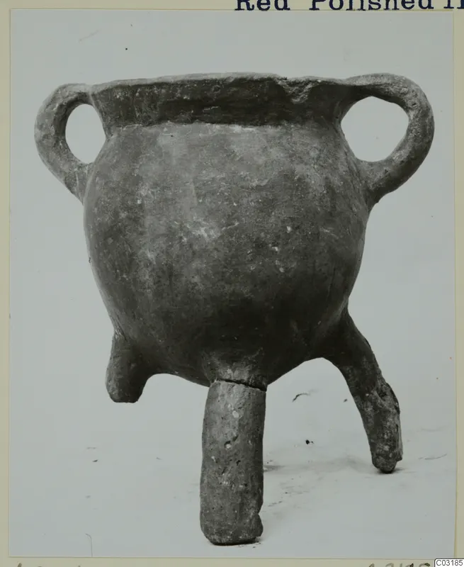 Pottery vessel with a rounded body, two loop handles and three short legs, from the Vrysi tou Barba tombs at Lapithos