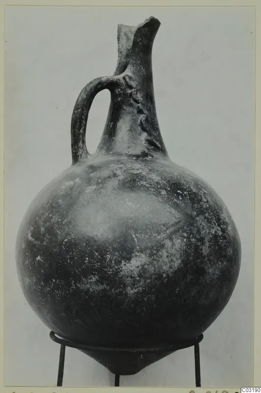 Red Polished I jug from Lapithos, with a strap handle and a pinched spout at the top