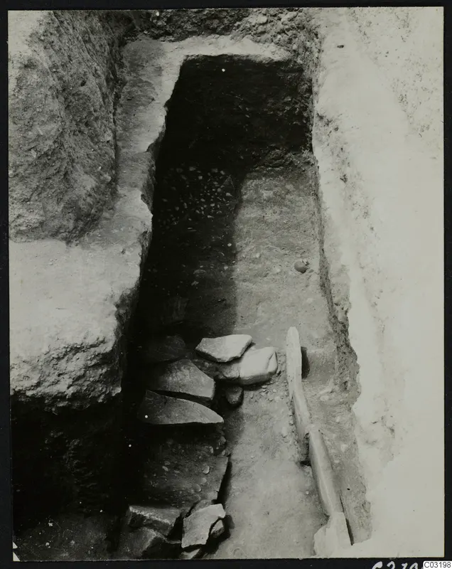 Tomb 8 at Amathus, upper layer: stone slabs step down toward a dark tomb opening in a cut passage