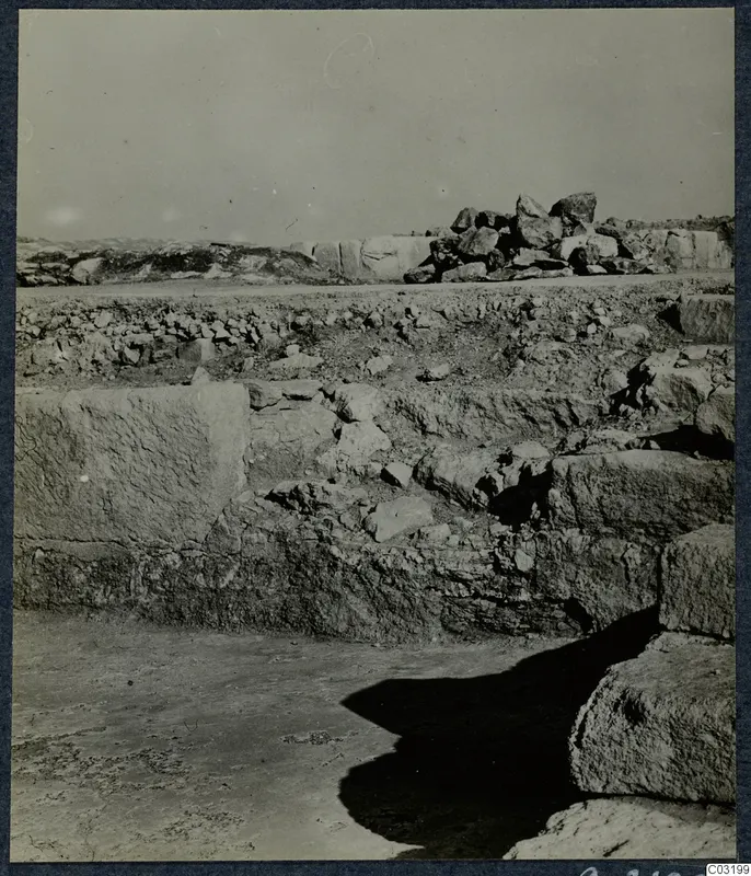 Large cut stone blocks and a stepped structure at the palace at Vouni, with rubble behind.