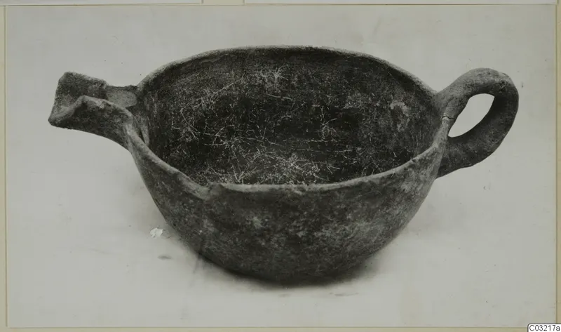 Pottery Red Polished III bowl from Ayios Iakovos with a loop handle on one side and a broken spout on the other.