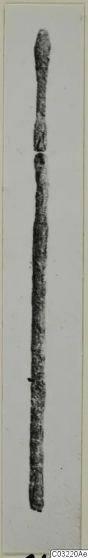 Long thin pin from Marion, photographed upright against a pale background