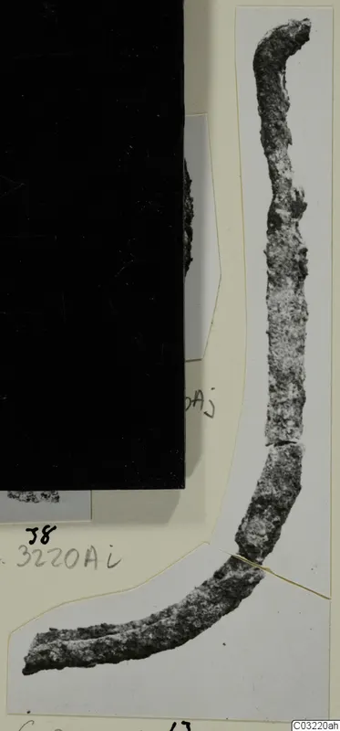 Corroded metal object from Marion, a long curved piece shown on a photo mount with handwritten labels.