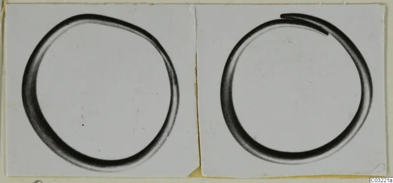 Two photographs of plain rings mounted side by side on a light card; the right ring has one end overlapping the other.