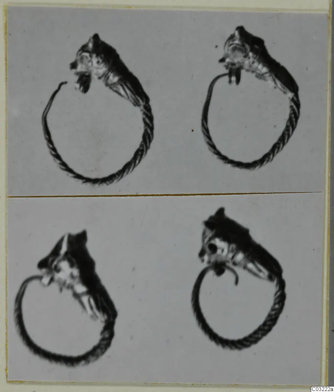 Four views of a gold twisted-wire ring with a head-shaped terminal, mounted on a grey card