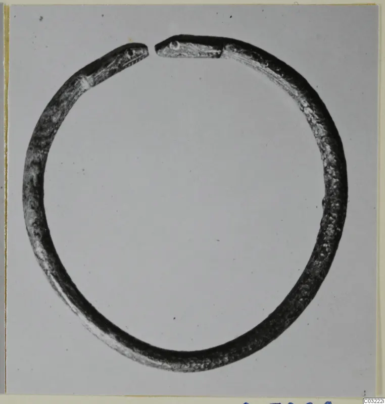 Silver bracelet, penannular, with flattened ends shaped like animal heads