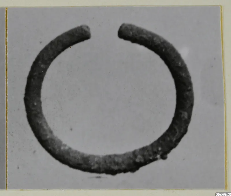 Open silver ring with two plain ends, photographed against a grey backdrop.
