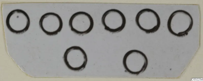 Eight dark ink rings drawn on a pale card, arranged in two rows of six and two.