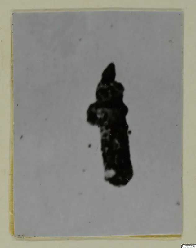 Corroded dark metal find, recorded as silver, shown on a grey backdrop mounted on a card