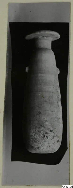 Pale stone vessel with a wide flat rim, narrow neck and two small handles, shown against a black backdrop