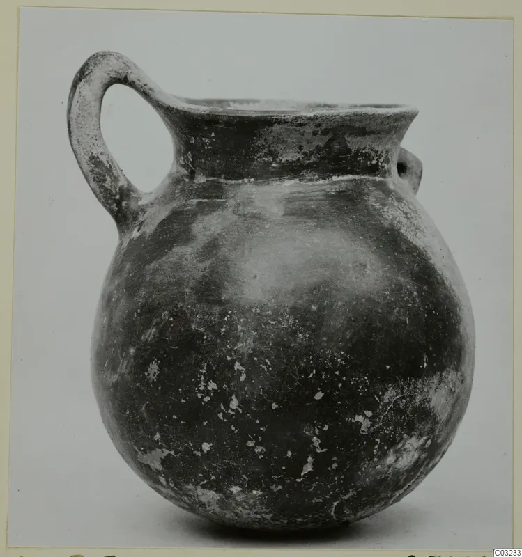 Pottery Red Polished III jug with a strap handle, from Lapithos
