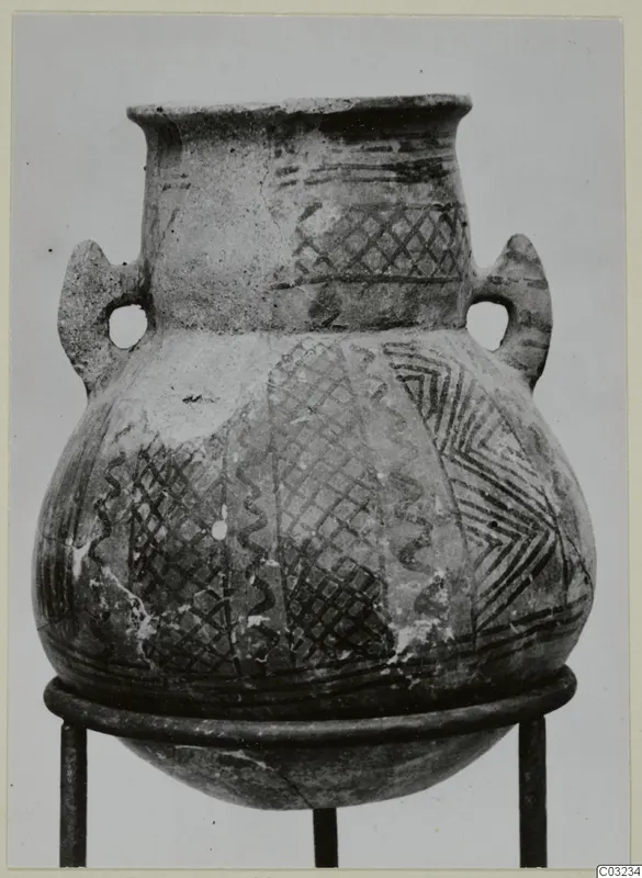 Two-handled White Painted pottery jar with crosshatched and zigzag bands, photographed on a metal stand.