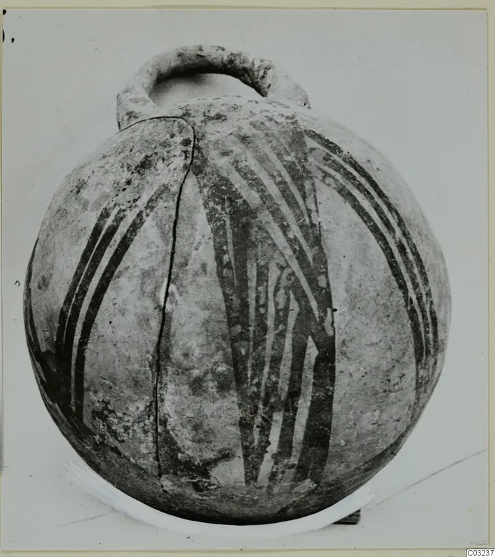 Round pottery vessel with a loop handle and dark painted bands, photographed against a light background.