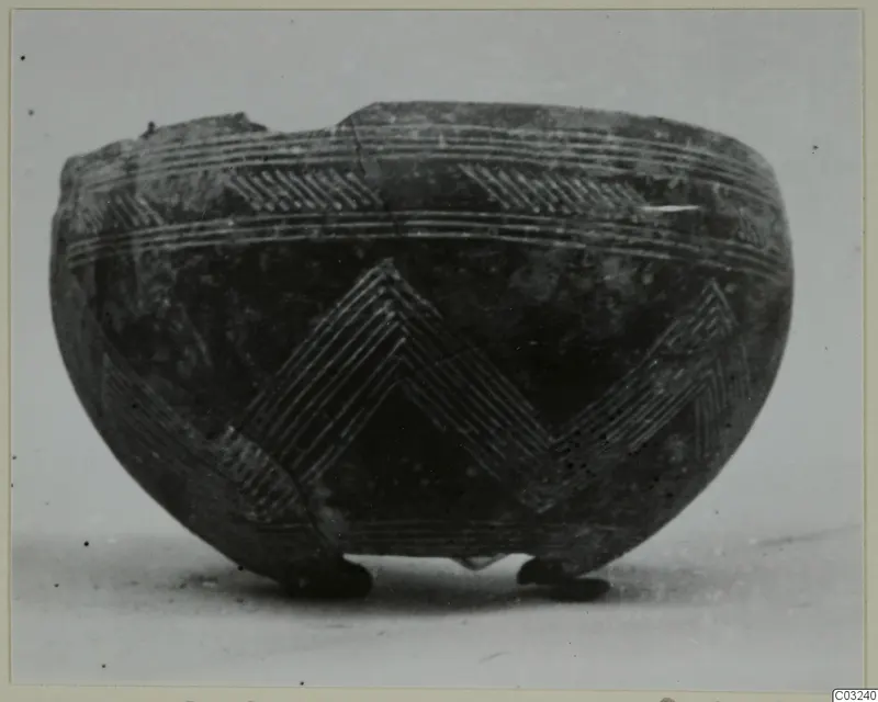 Black Polished bowl from Lapithos with incised chevron and banded decoration, standing on three small feet