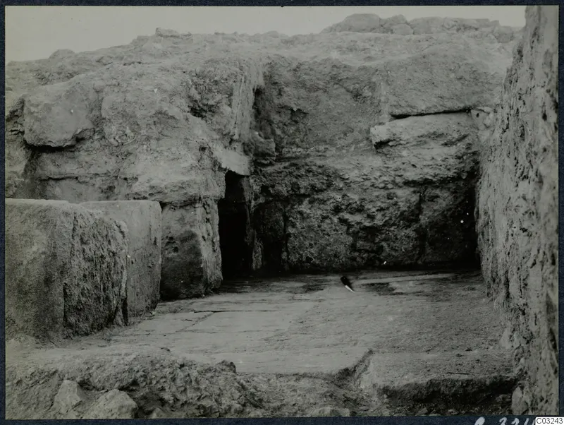 Excavated area at the palace at Vouni, with large stone blocks, a dark doorway and a paved stone floor