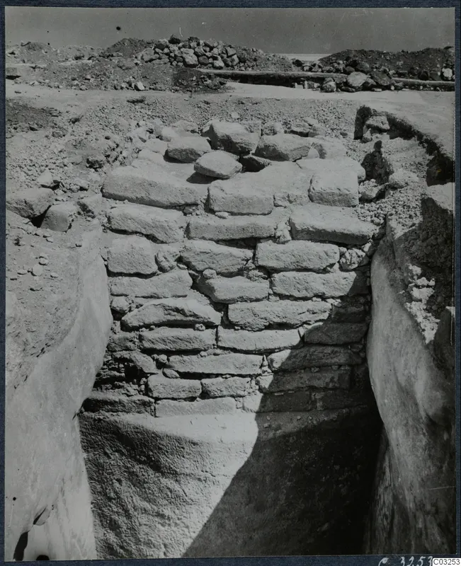 Excavated stone wall of rough blocks in a deep trench at the palace at Vouni