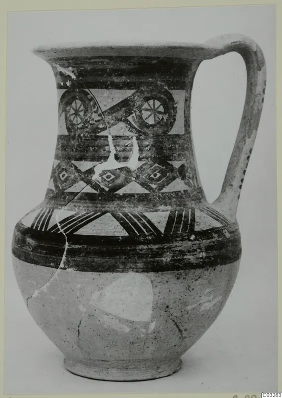 Pottery Bichrome Wheel-made jug from Milia, with painted bands and roundel motifs on the neck