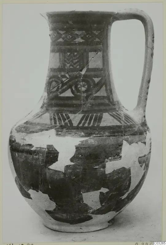Painted pottery jug with a single loop handle and geometric bands, from Milia.