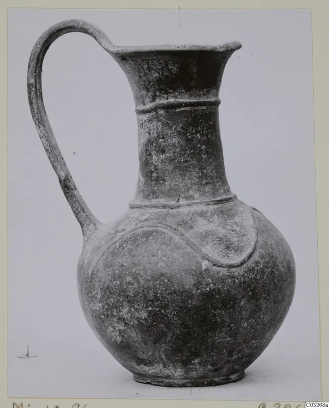 Pottery jug with a single loop handle, flared mouth and raised band on the body, from Milia