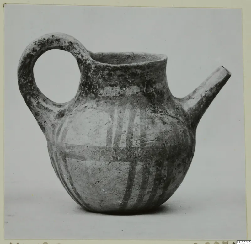Pottery juglet with a loop handle, a spout and painted white bands on a dark body