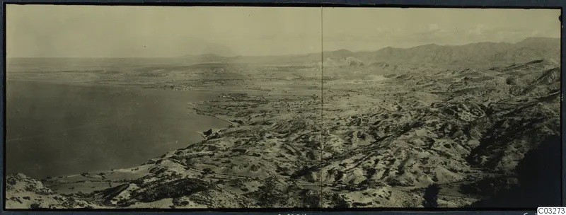 Panoramic view over a coastal bay and dry scrubby hills at Vouni