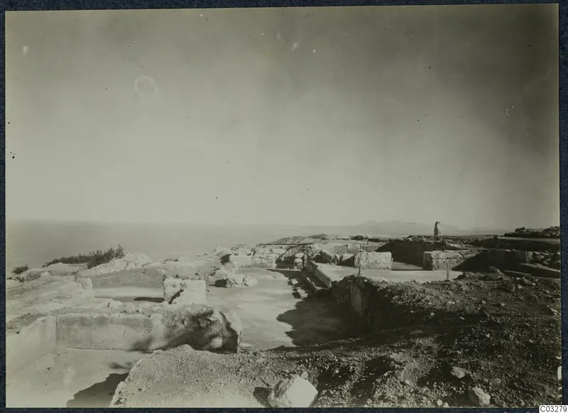 Excavated ruins of the palace at Vouni with cut stone walls and the sea beyond