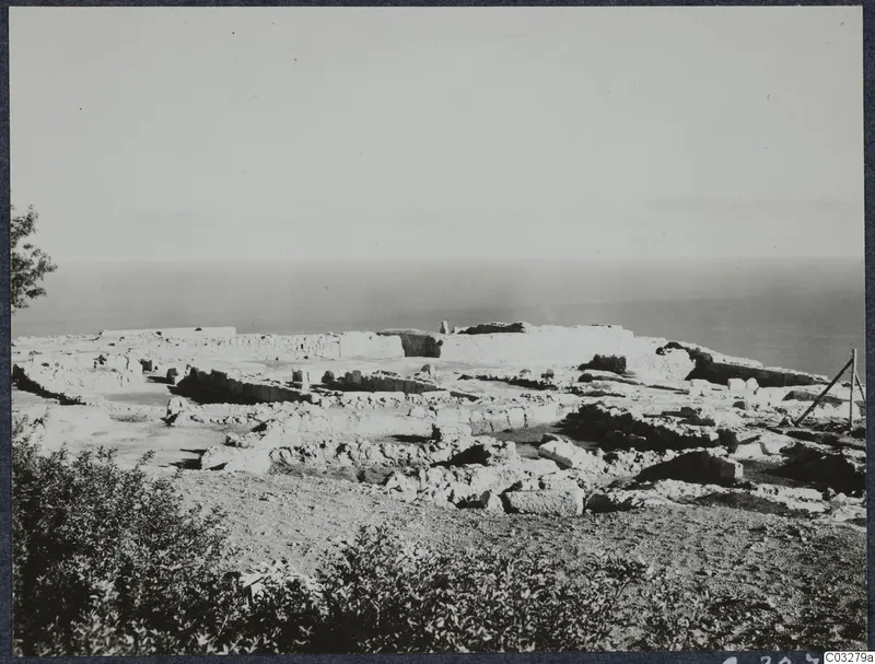 Ruined walls and scattered stones of the palace at Vouni on a hilltop, with the sea behind