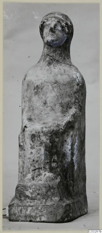 Terracotta figurine with folded arms on a low rectangular base, from Marion tombs 46–60 finds