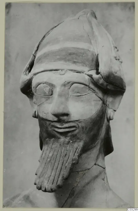 Terracotta head and bust of a bearded figure in a tall cap, Proto-Cypriote II