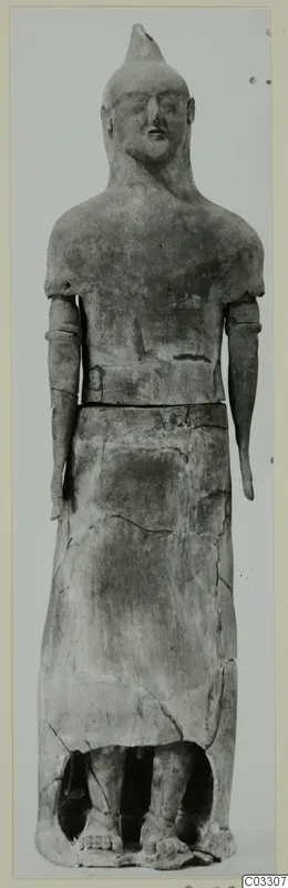 Terracotta Proto-Cypriote I, a standing terracotta figure with a pointed head, photographed frontally against a plain backdrop