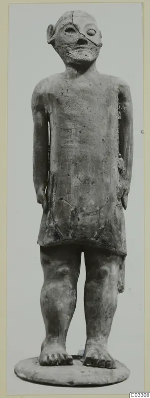 Standing terracotta figure of a Proto-Cypriote type from Ayia Irini, arms at its sides, on a round base